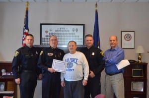 Photo courtesy of the Dearborn Police Department. Dearborn Police Reserve Officer Keith Redlin (left), Police Chief Ronald Haddad, Sgt. David Marshall (fourth from left) and Lt. Douglas Topolski recognized retired Reserve Officer Allen Konkel (third from left) for his 24 years of service as a reserve officer in Dearborn on Jan. 23.