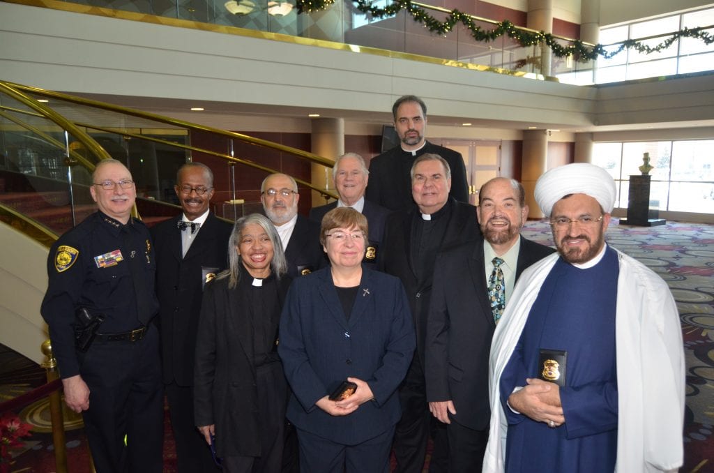 Photo courtesy of the city of Dearborn Dearborn Mayor John B. O’Reilly, Jr. (first row second from right) welcomed new Police Department chaplains in December. He was joined by Police Chief Ronald Haddad (second row left). The chaplains, from houses of worship in Dearborn or the region, are (first row): the Rev. Deborah Satterwhite, the Rev. Pastor Fran Hayes, and Imam Mohammad Ali Elahi, the Rev. Oscar W. King III (second row second from left), Imam Radwan Mohmad Mardini, Rabbi Emeritus David Nelson, the Rev. Rami Abdulmashih and the Rev. Terry Kerner.