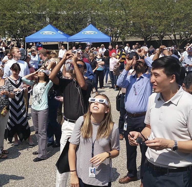 Photo by Mark Sawyer Ford Motor Co. employees watch the Aug. 21 total solar eclipse outside the World Headquarters office in Dearborn. The best visibility for the solar eclipse in metropolitan Detroit took place just before 2:30 p.m. where the moon covered 79 percent of the sun. For the first time in 99 years people were able to view the solar eclipse from coast to coast in the United States.