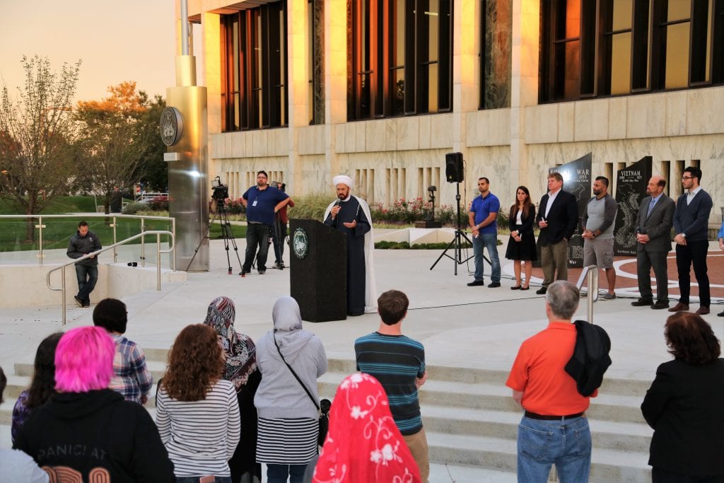 Photo by Abbas M. Shehab Islamic House of Wisdom Imam Mohammad Elahi honors the victims of the Las Vegas shooting during a candlelight vigil at Henry Ford Centennial Library on Oct. 8. During the vigil, candles were lit by residents, community leaders and elected officials while praying for a full recovery of the survivors and their families. The Las Vegas shooting took place on Oct. 1 when Stephen Paddock began shooting from a room on the 32nd floor of Mandalay Bay Resort and Casino at a crowd attending the final day of the Route 91 Harvest Music Festival killing 58 people and injuring almost 500.