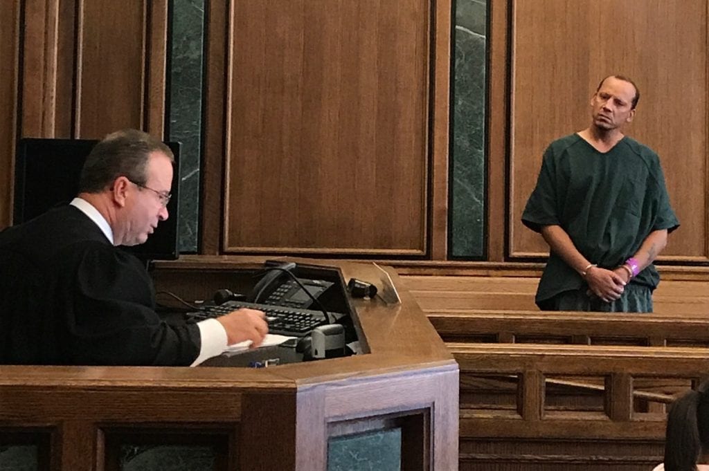 Photo by Zeinab Najm Nineteenth District Court Judge Mark Somers (left) reads multiple arson charges against Inkster resident David Cerne, accused of throwing an explosive firework into Divine Child Church during prayer service on Aug. 23.