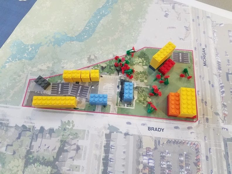 Photo courtesy of the city of Dearborn Attendees at an April 30 open house for the potential redevelopment of the vacant property at Michigan Avenue and Brady use maps and Legos to create their own designs for how they would arrange a concept for the site.